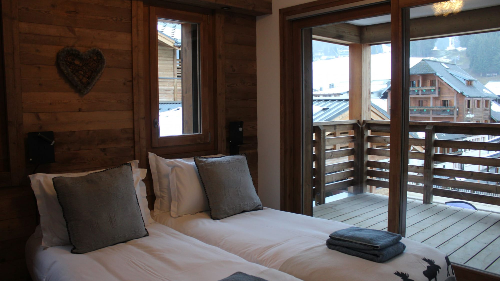 Master bedroom with balcony and view on snowy village